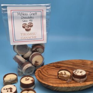 Tiramisu Ganache with chocolates in wooden bowl and cut chocolate